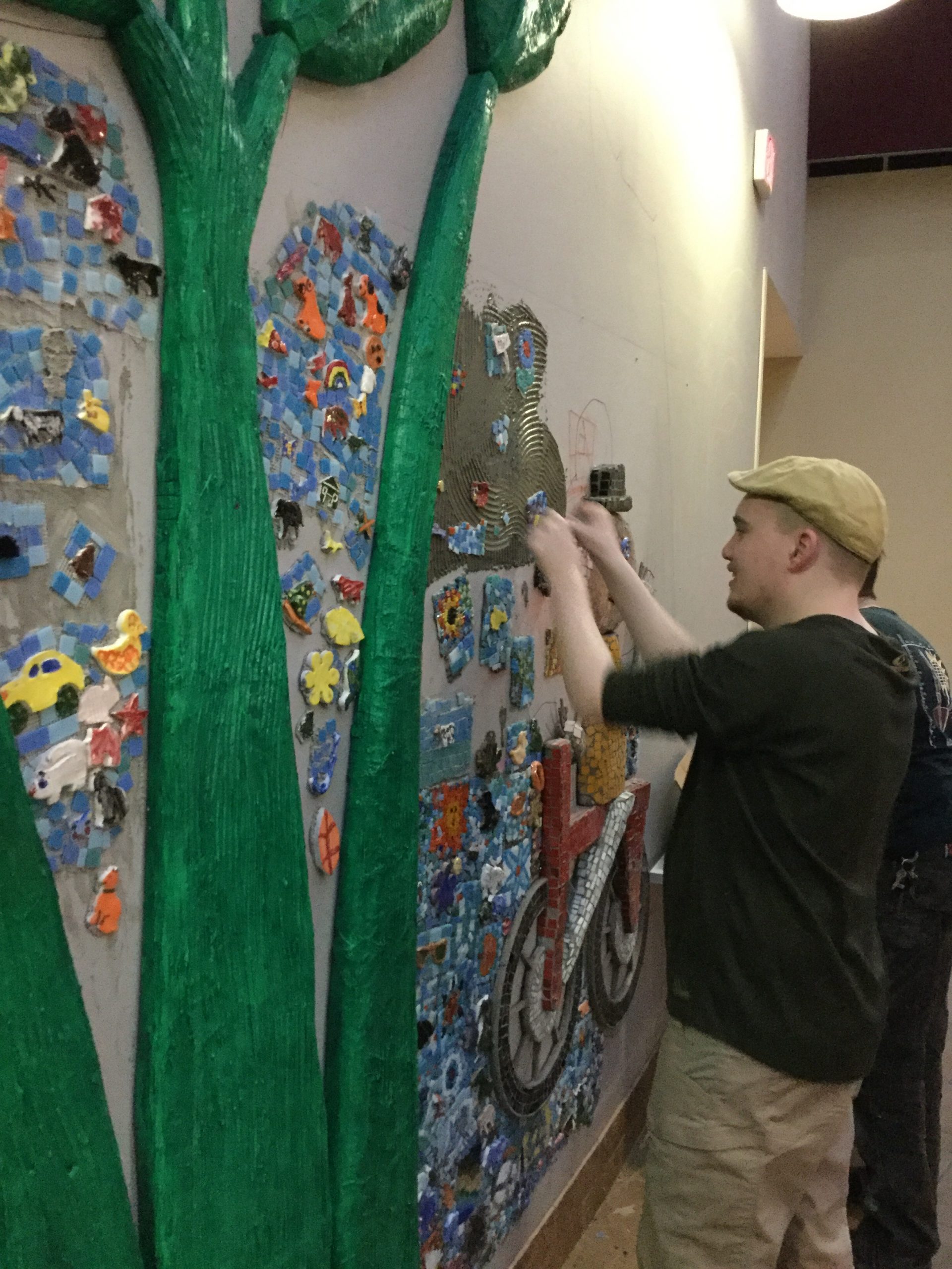 Students at Morris-Union Jointure Commission put the finishing touches on their garden mosaic mural.