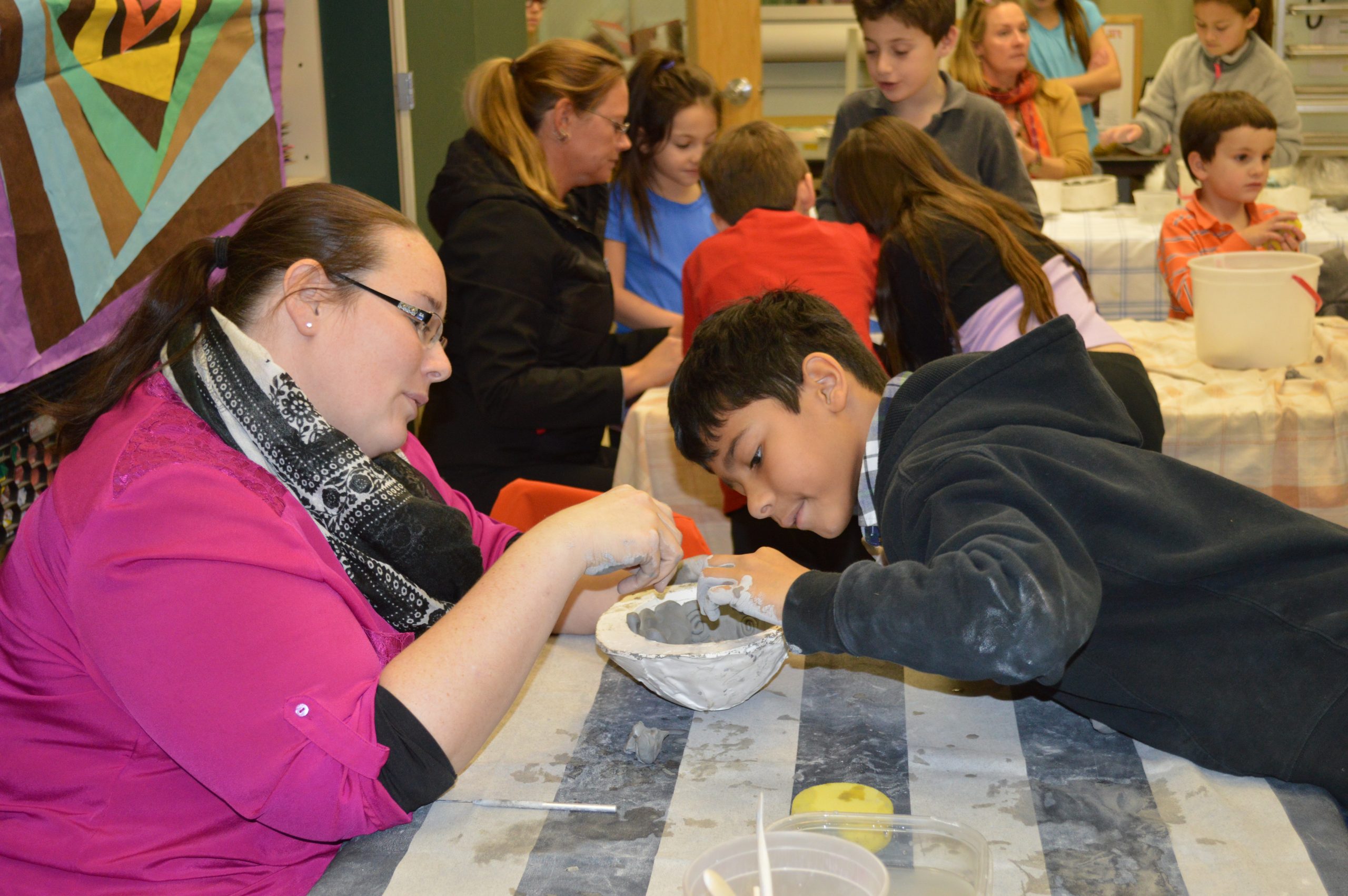 Students teach community members how to create giving bowls at Bradley Beach Elementary School.