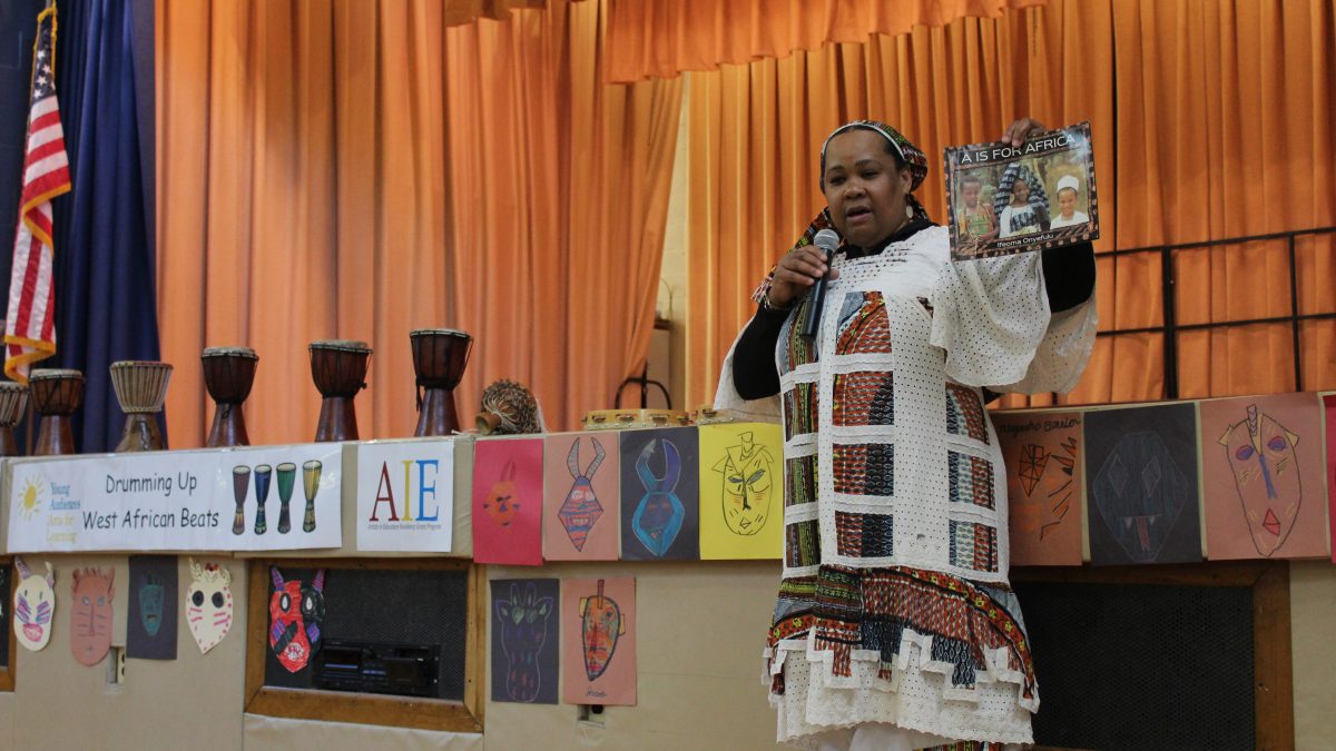 Candace Hundley-Kamate begins the Culminating Event at Charles Olbon School.