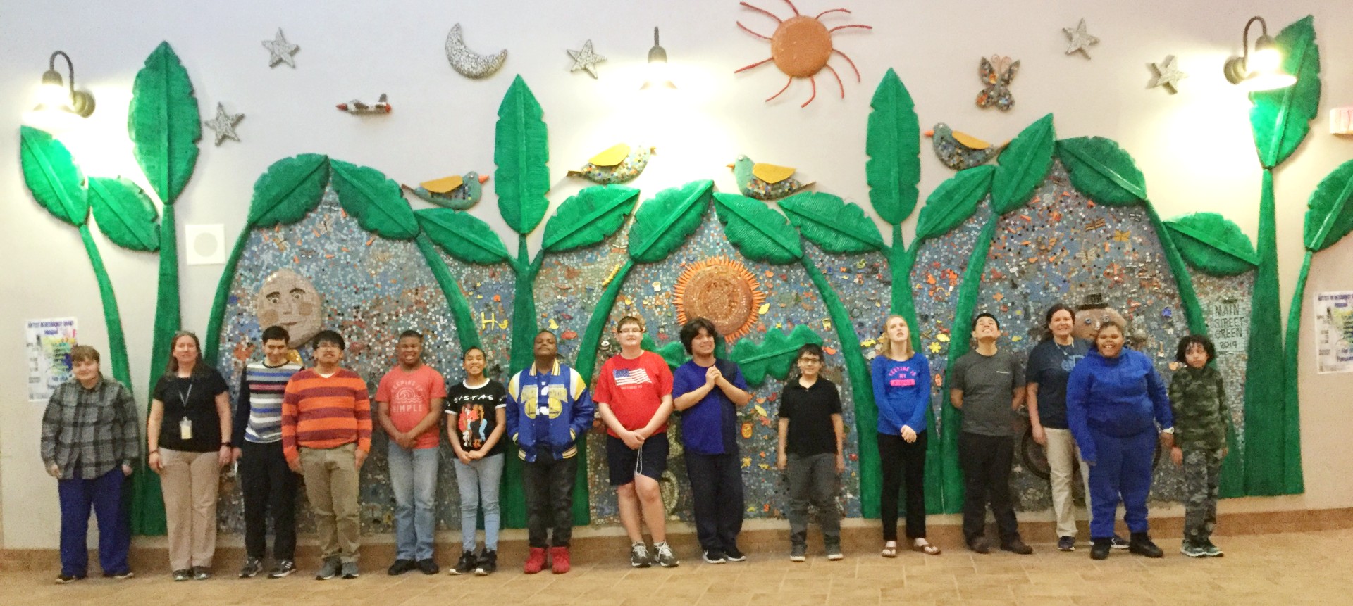 Students and faculty from Morris-Union Jointure Commission pose in front of a two-year mural project led by teaching artist Marilyn Keating.